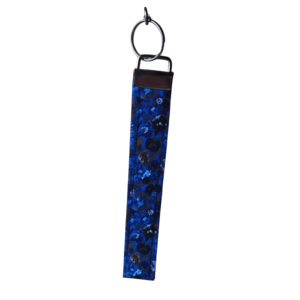 Wristlet with a dark blue and black floral abstract pattern and silver clasp and keyring