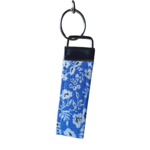Fabric wristlet key ring strap in a bright blue and white floral pattern with silver hardware.